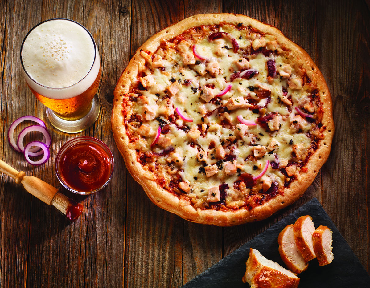 Pizza beer and barbeque sauce on wooden table